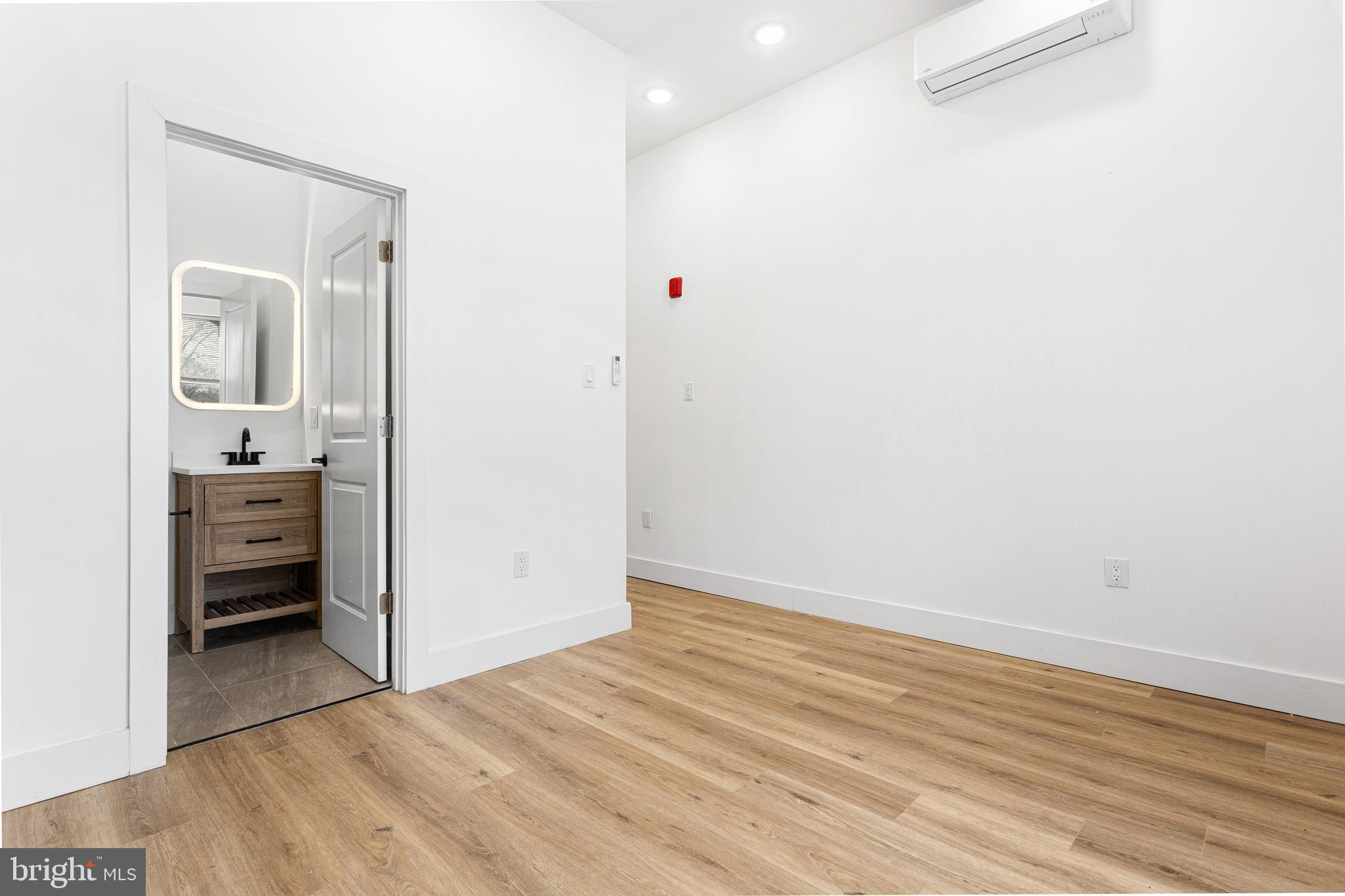 2317 North 33rd Street, Unit D Philadelphia, PA 19132 - Photo 3 of 12 a view of a hallway to a room and wooden floor