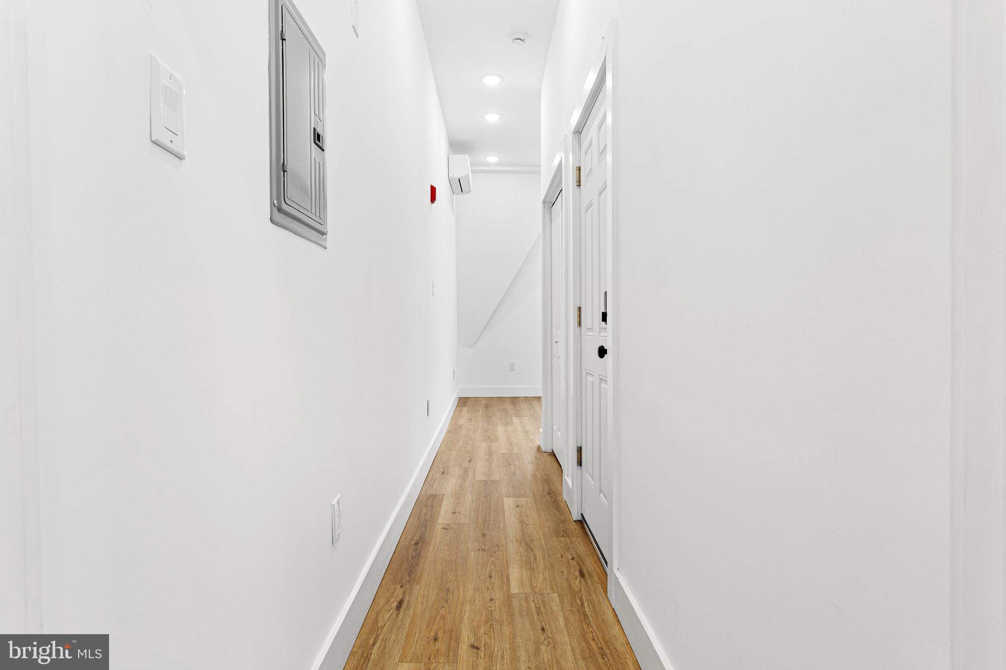2317 North 33rd Street, Unit D Philadelphia, PA 19132 - Photo 8 of 12 a view of a hallway with wooden floor and staircase