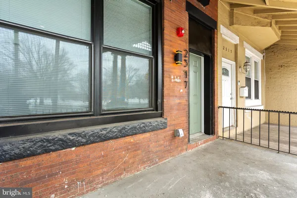 a view of a brick house with a large window