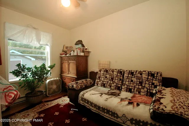 a bedroom with a bed and a desk