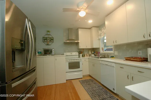 a kitchen with a sink cabinets and stainless steel appliances