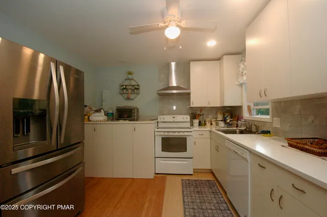 a kitchen with a sink stainless steel appliances and cabinets
