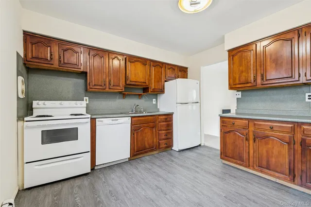 an empty room with a window and a ceiling fan
