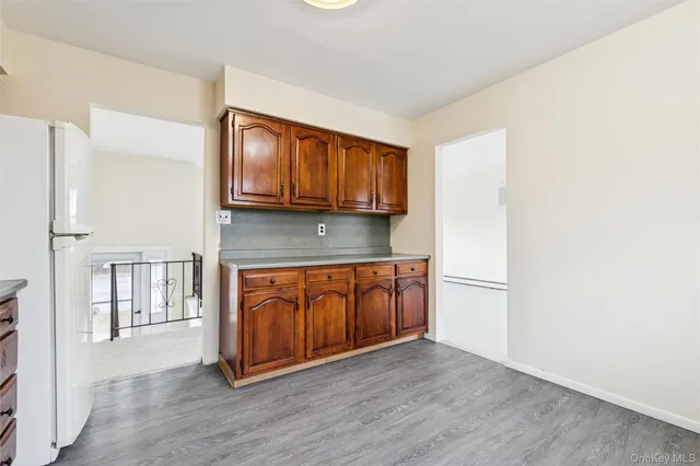 a kitchen with a refrigerator sink and cabinets