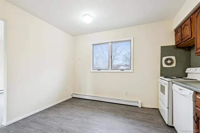 a kitchen with a refrigerator and a stove top oven