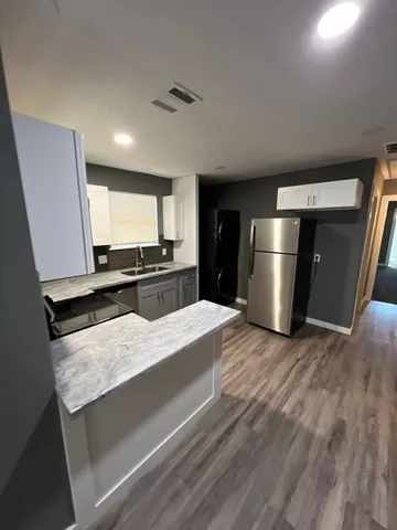 a kitchen with stainless steel appliances a refrigerator and a stove