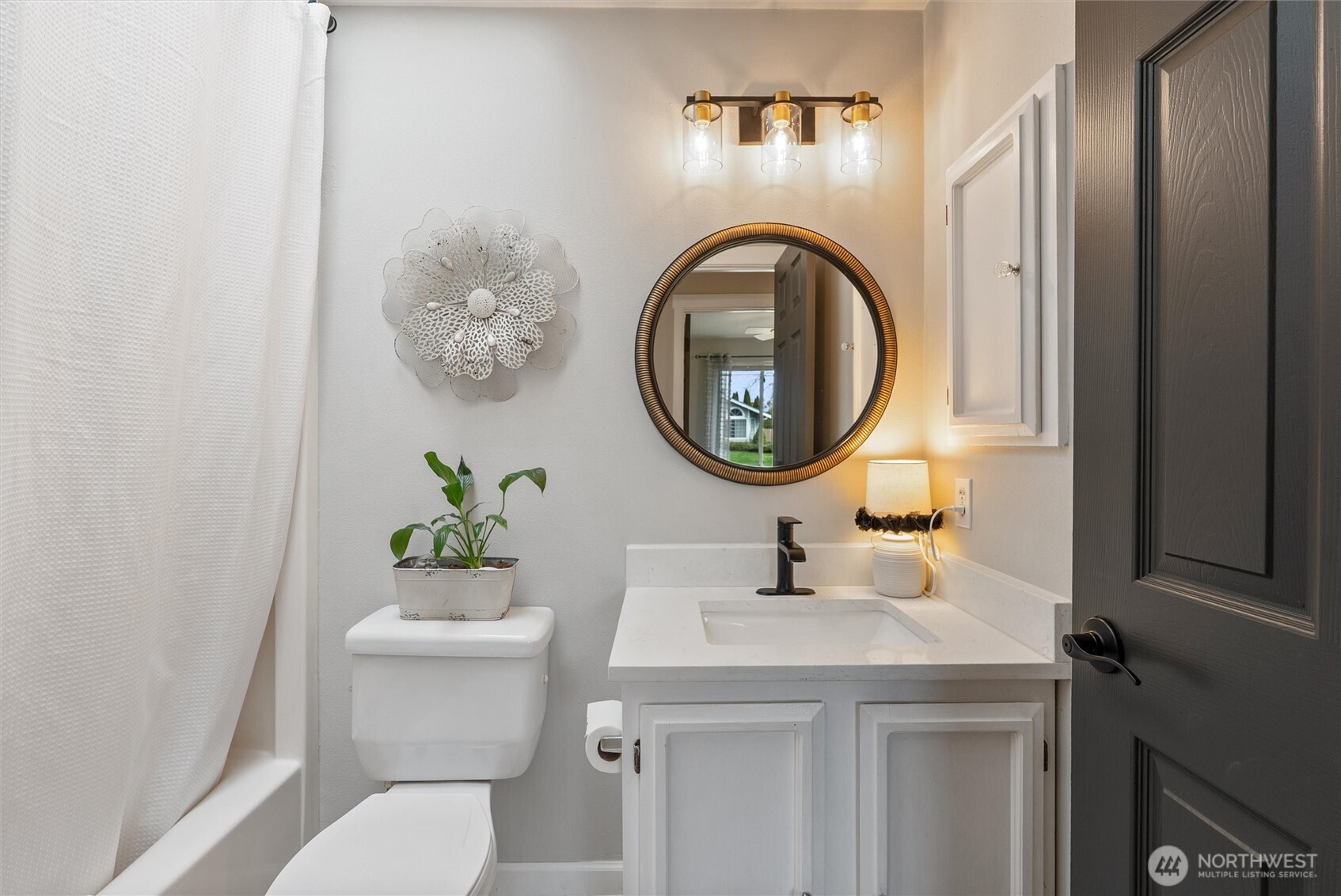 24912 168th Place Southeast Covington, WA 98042 - Photo 17 of 23 a bathroom with a toilet a sink and a mirror