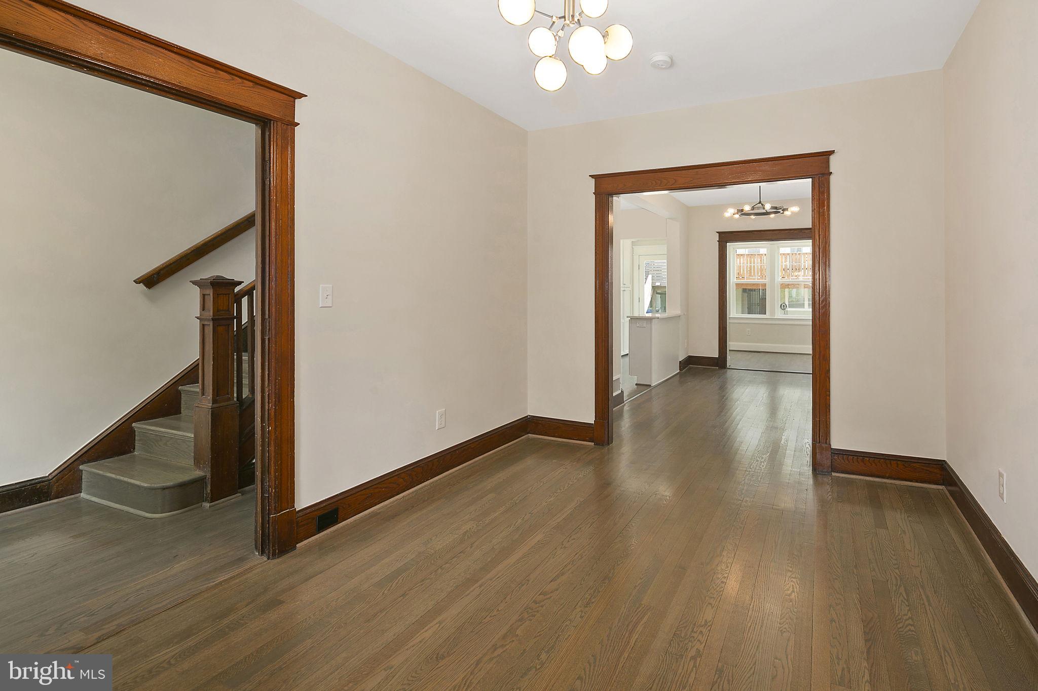 1242 Oates Street Northeast Washington, DC 20002 - Photo 14 of 47 a view of a hallway with wooden floor and staircase