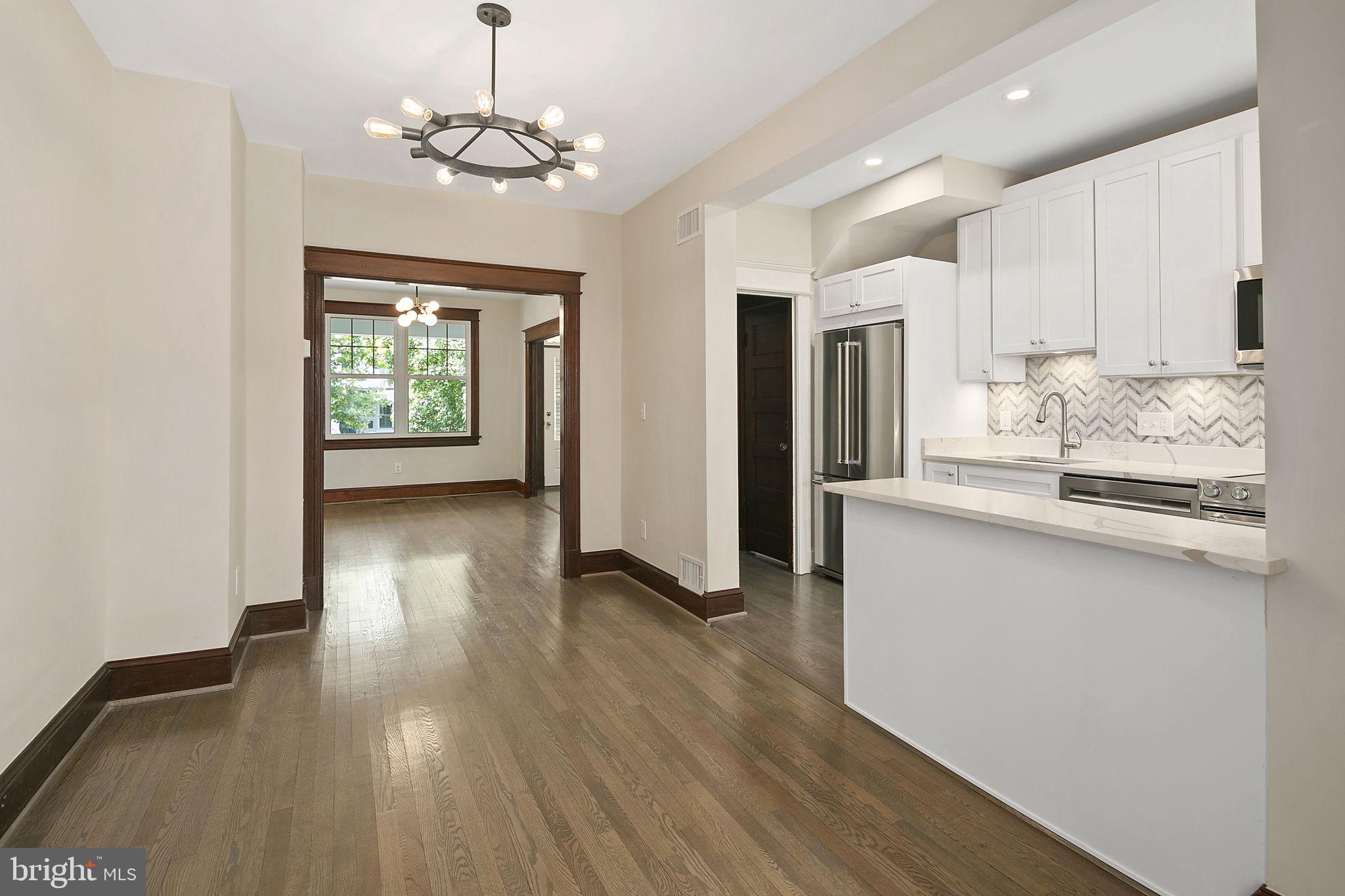 1242 Oates Street Northeast Washington, DC 20002 - Photo 17 of 47 a view of a kitchen with granite countertop wooden floor and stainless steel appliances
