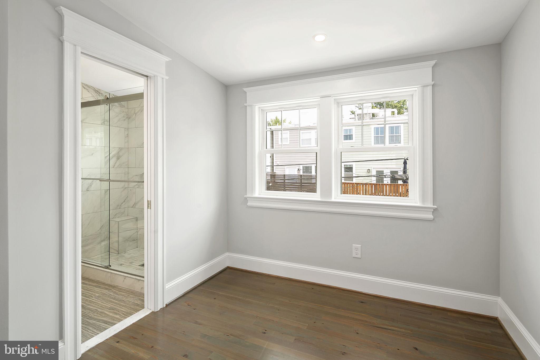 1242 Oates Street Northeast Washington, DC 20002 - Photo 26 of 47 an empty room with wooden floor and windows