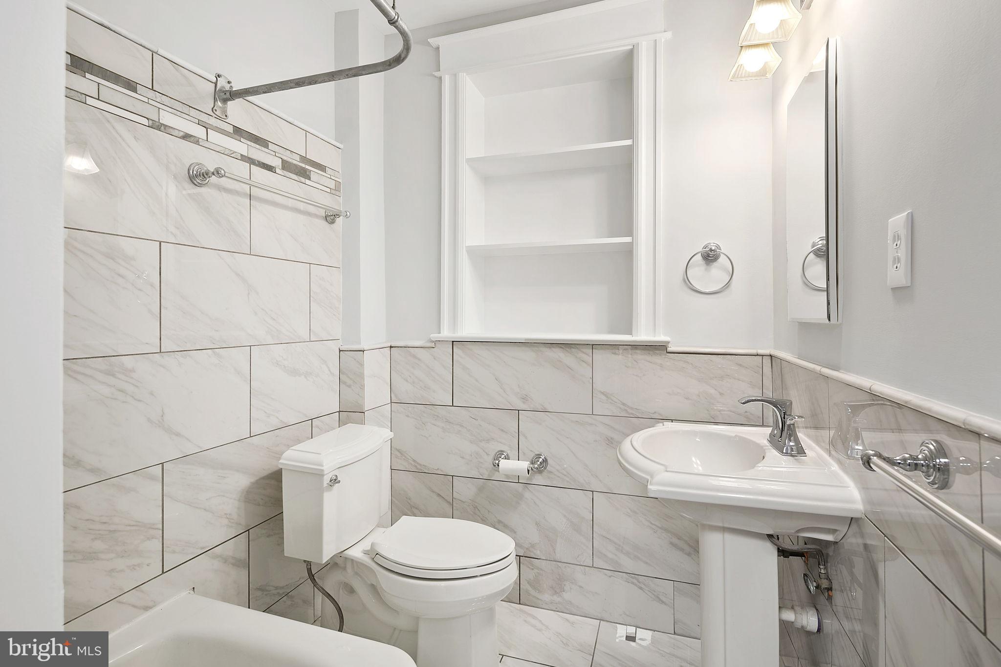 1242 Oates Street Northeast Washington, DC 20002 - Photo 27 of 47 a bathroom with a sink toilet and shower