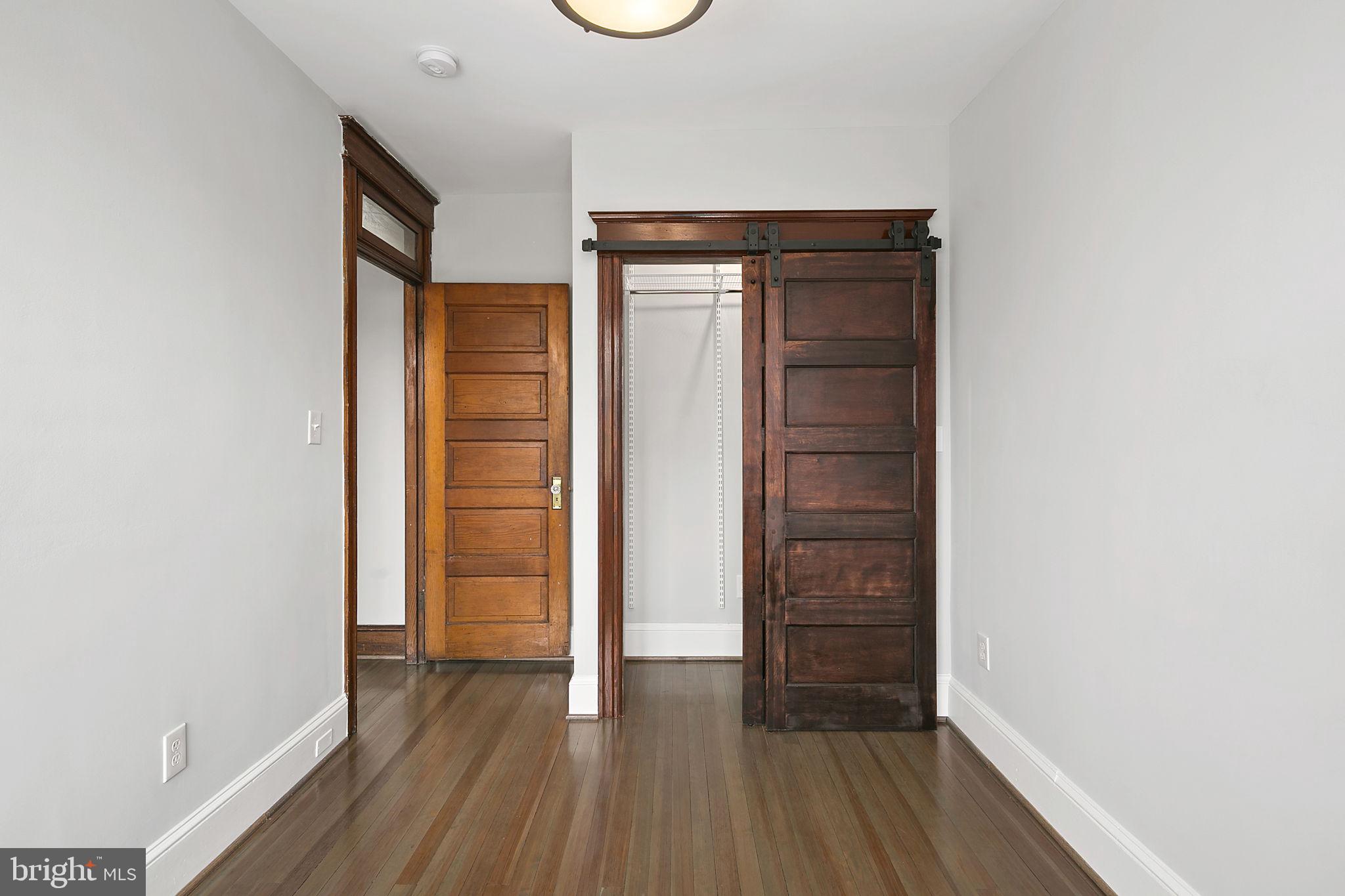 1242 Oates Street Northeast Washington, DC 20002 - Photo 28 of 47 a view of walk in closet with empty racks
