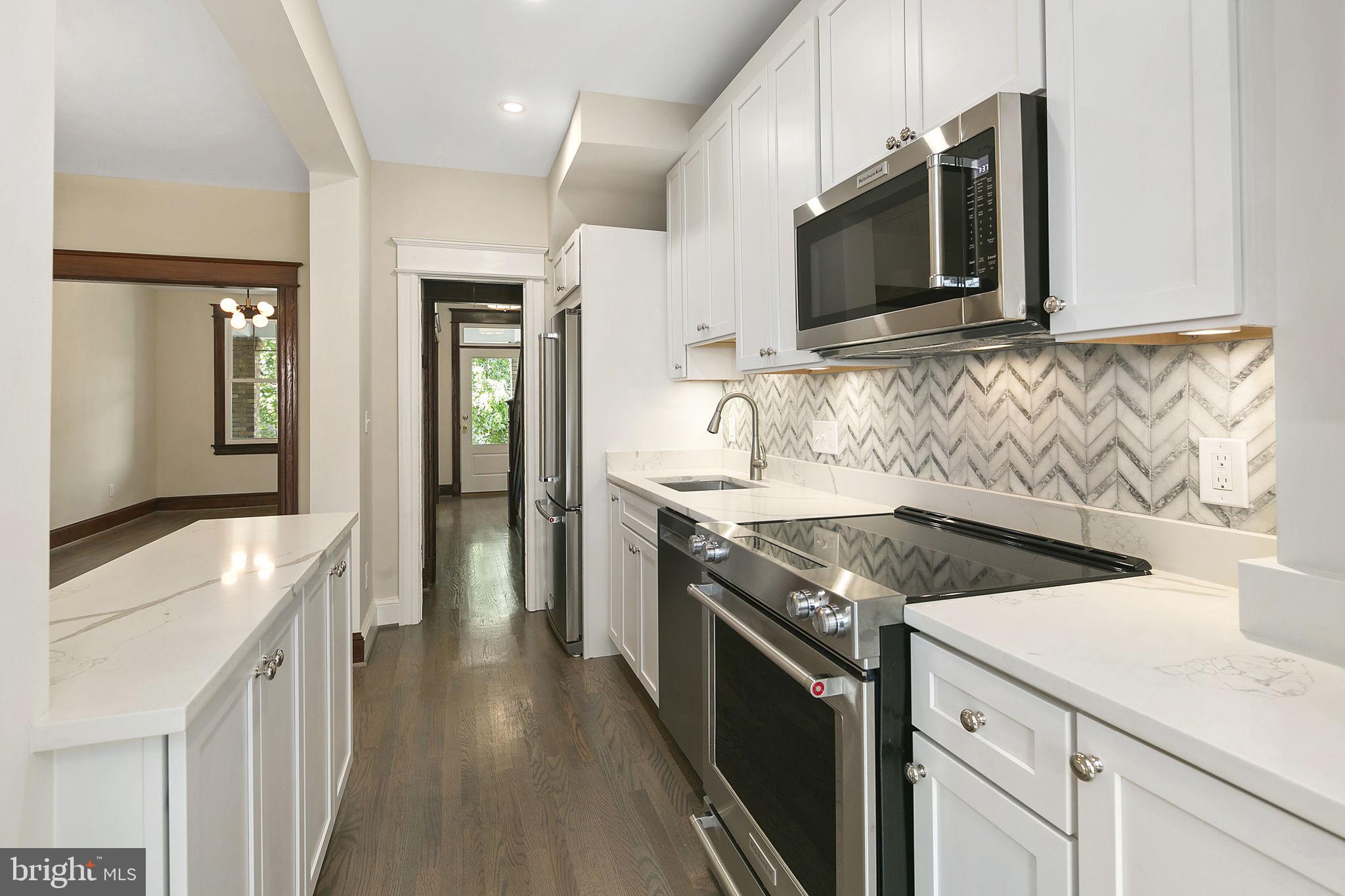 1242 Oates Street Northeast Washington, DC 20002 - Photo 3 of 47 a kitchen with stainless steel appliances granite countertop a sink and a stove