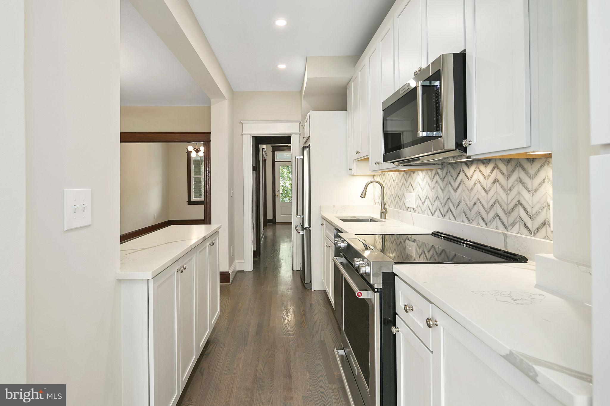 1242 Oates Street Northeast Washington, DC 20002 - Photo 38 of 47 a kitchen with a sink stove and refrigerator