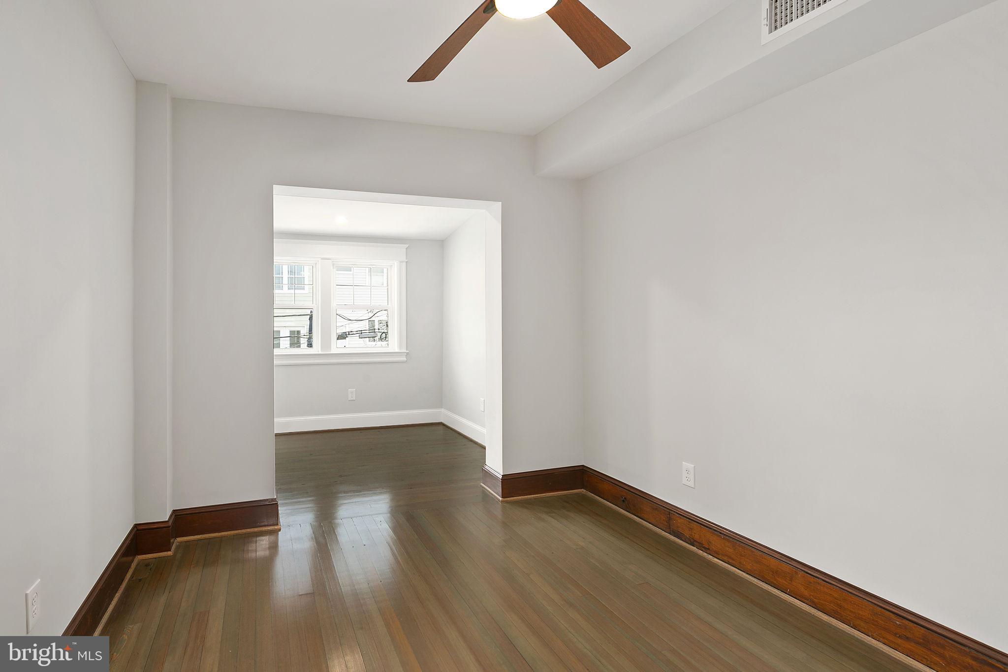1242 Oates Street Northeast Washington, DC 20002 - Photo 41 of 47 an empty room with wooden floor and windows