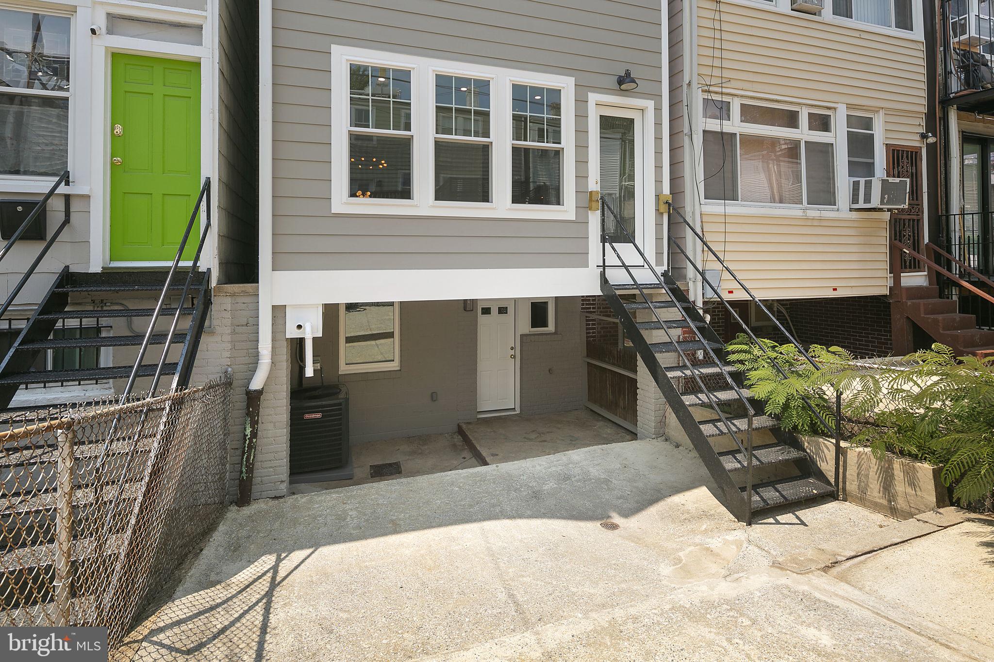 1242 Oates Street Northeast Washington, DC 20002 - Photo 45 of 47 a front view of a house with a yard