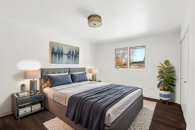 a bedroom with bed and a potted plant