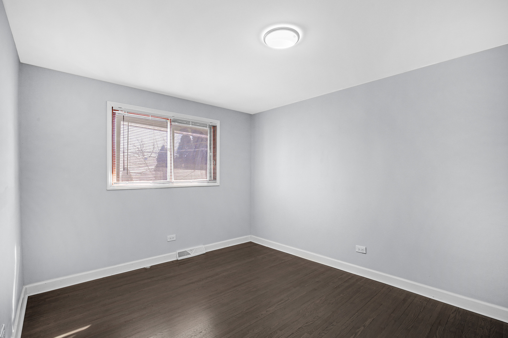 16779 92nd Avenue Orland Hills, IL 60487 - Photo 19 of 26 a view of an empty room with wooden floor and a window