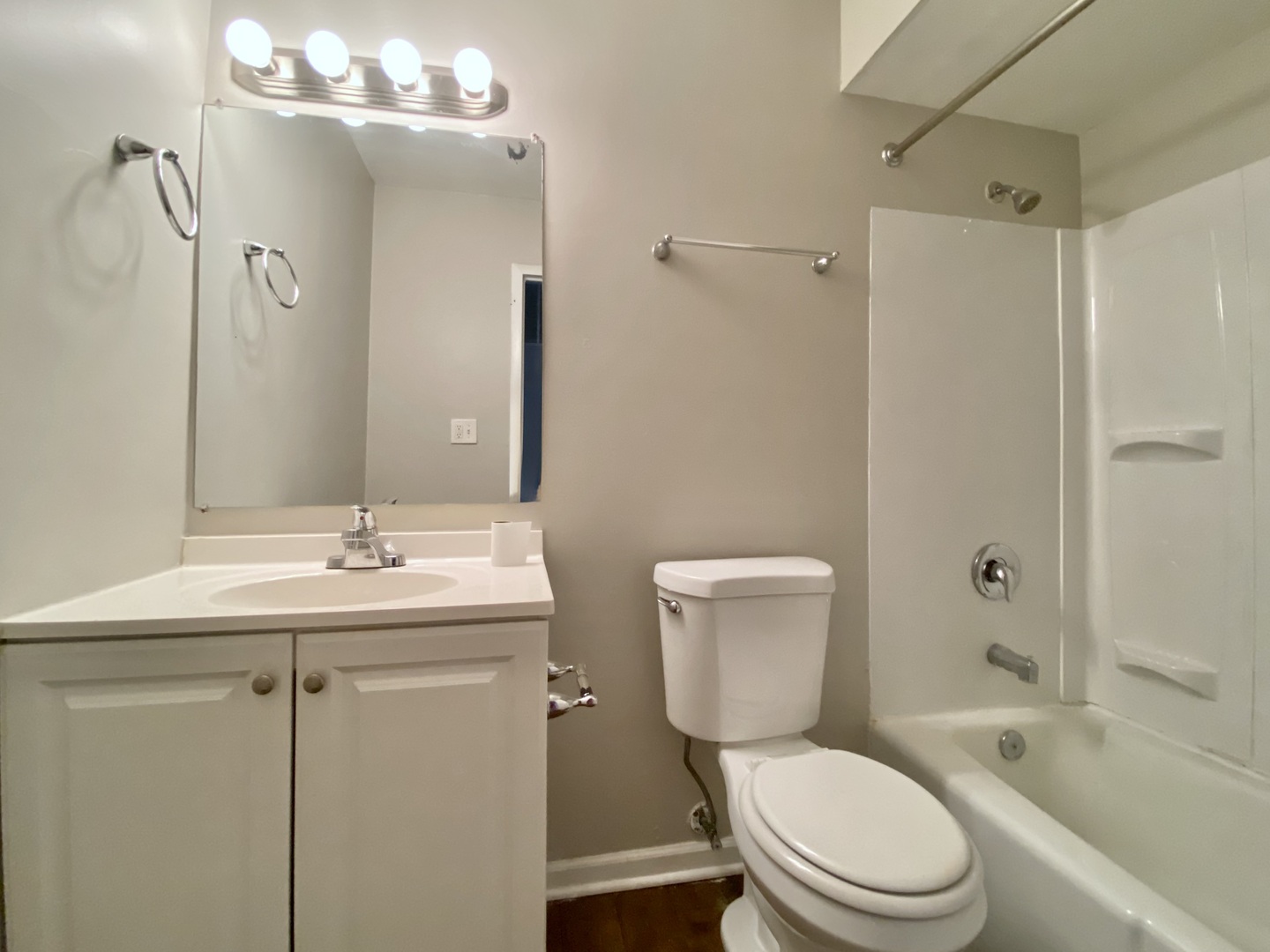317 East Schaumburg Road Streamwood, IL 60107 - Photo 23 of 25 a bathroom with a toilet a sink a mirror a bathtub and shower
