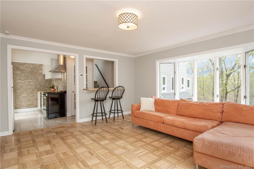 a living room with furniture and a floor to ceiling window