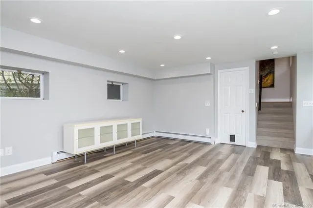 a view of an entryway with wooden floor and windows