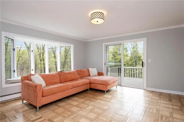 a living room with furniture and a large window