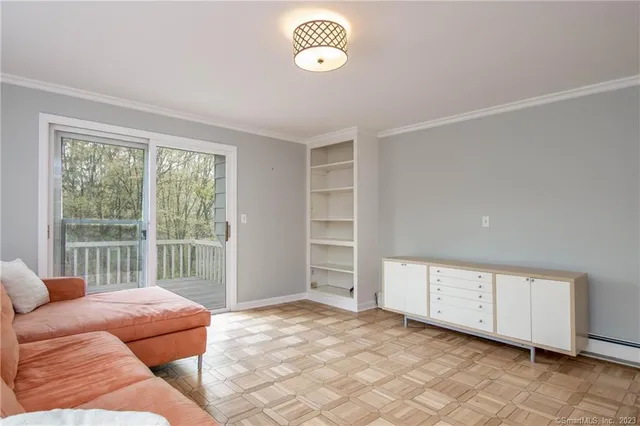 a bedroom with furniture and a large window