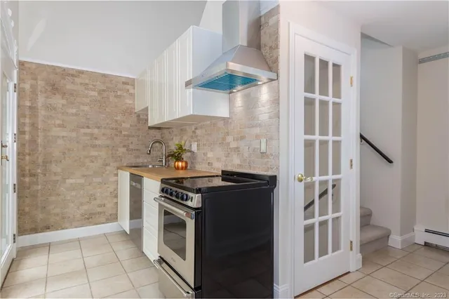 a kitchen with stainless steel appliances granite countertop a stove and a refrigerator
