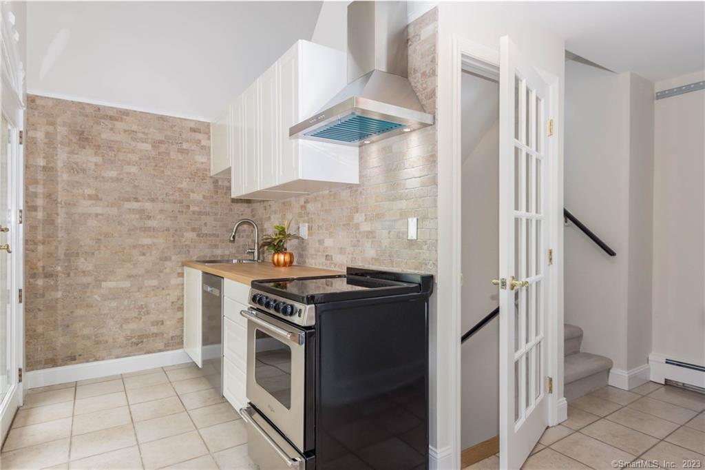 241 Maple Road Easton, CT 06612 - Photo 7 of 21 a kitchen with stainless steel appliances a stove and a refrigerator