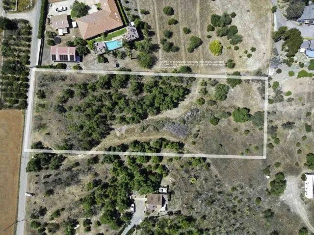 an aerial view of a houses with a yard