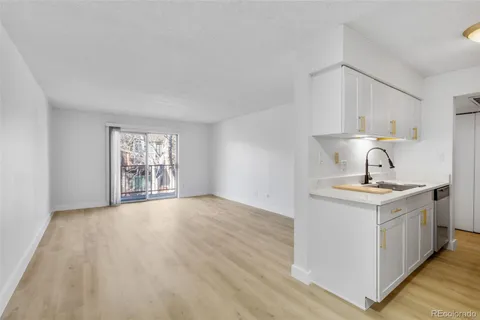 a kitchen with a sink cabinets and window