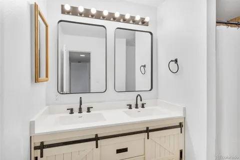 a bathroom with a sink vanity and a mirror