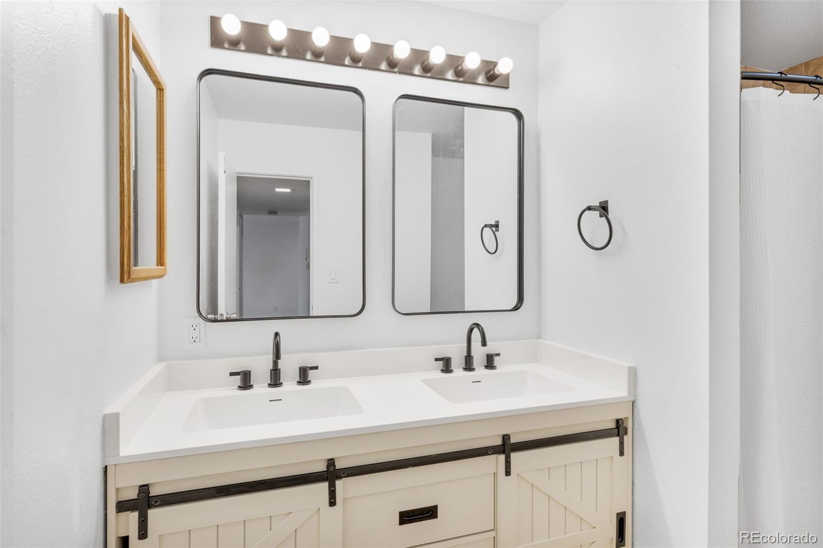 7755 East Quincy Avenue, Unit 303A5 Denver, CO 80237 - Photo 22 of 35 a bathroom with a sink vanity and a mirror