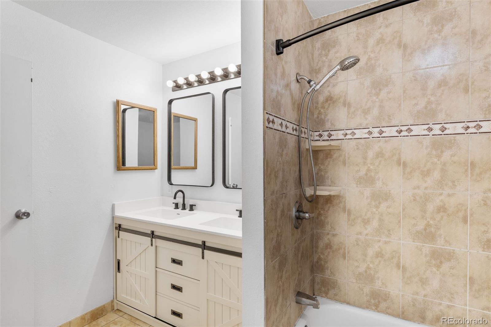 7755 East Quincy Avenue, Unit 303A5 Denver, CO 80237 - Photo 23 of 35 a bathroom with a sink vanity and a mirror