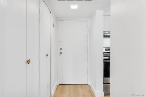 a view of a hallway with wooden floor