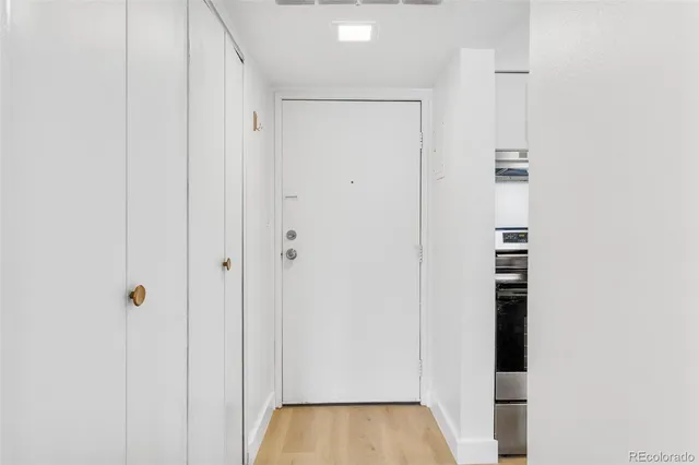 a view of a hallway with wooden floor