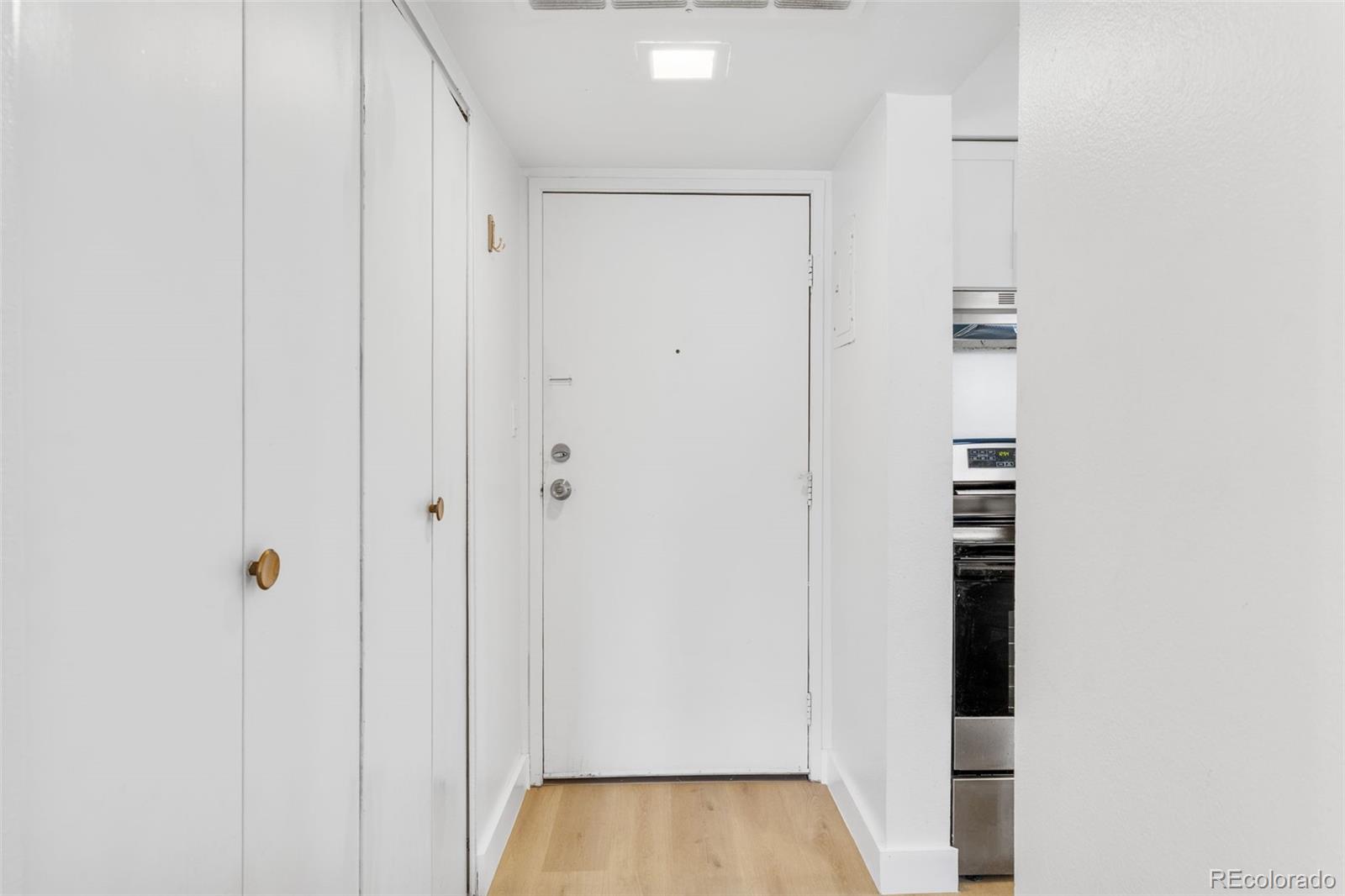 7755 East Quincy Avenue, Unit 303A5 Denver, CO 80237 - Photo 3 of 35 a view of a hallway with wooden floor