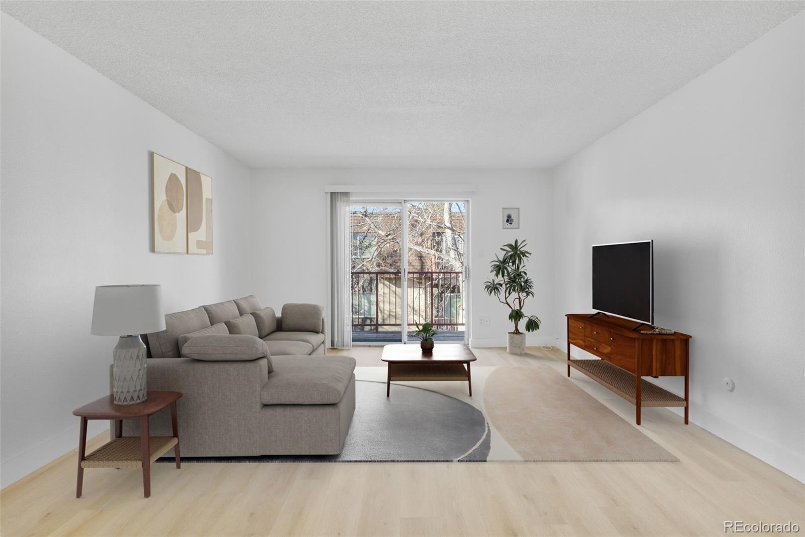7755 East Quincy Avenue, Unit 303A5 Denver, CO 80237 - Photo 4 of 35 a living room with furniture and a flat screen tv