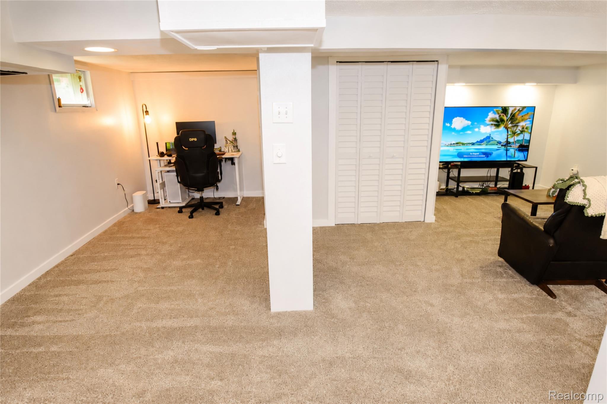 1405 Middle Road Highland, MI 48357 - Photo 15 of 18 Expansive carpeted area featuring recessed lighting, a white bi-fold door, and a partially visible window