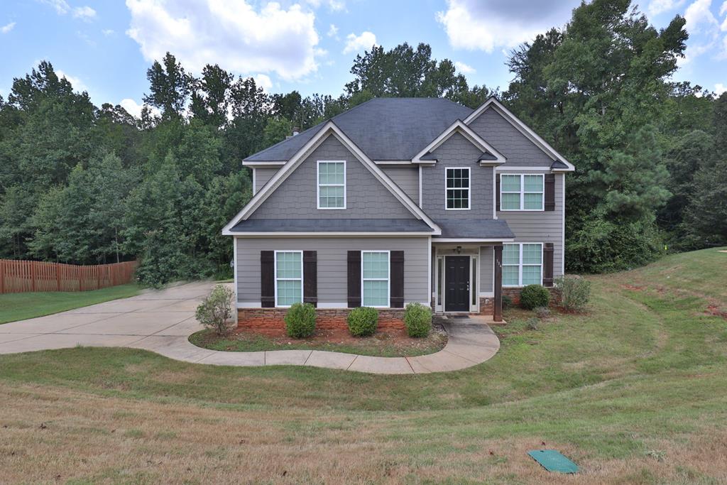 a front view of a house with a yard