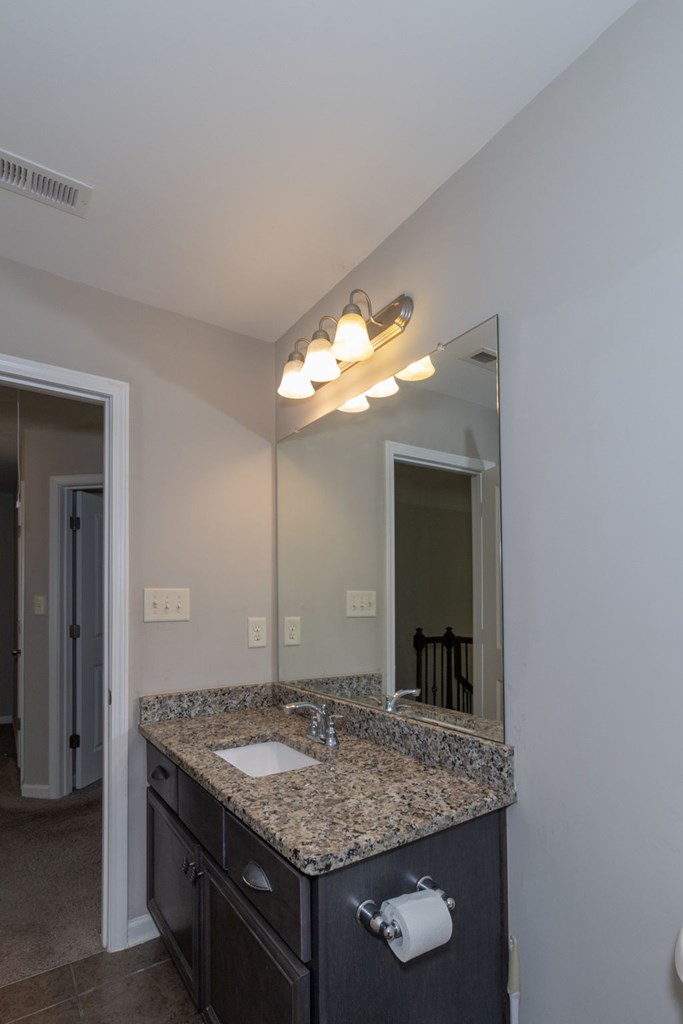 104 Pin Oak Way Hamilton, GA 31811 - Photo 23 of 41 a bathroom with a granite countertop sink and a mirror