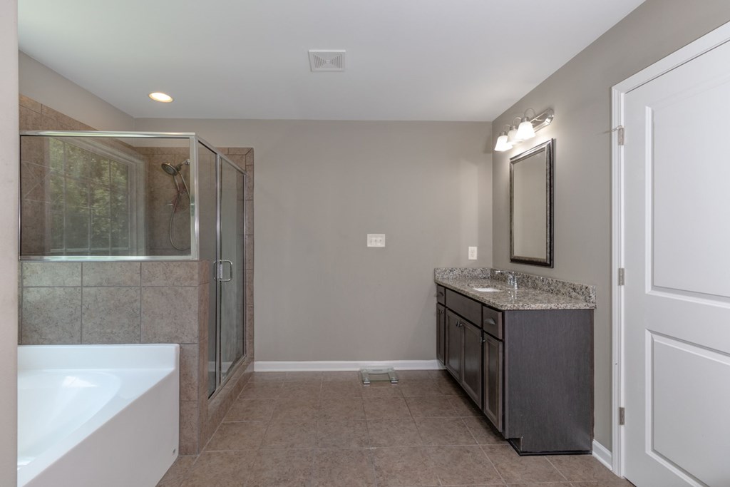 104 Pin Oak Way Hamilton, GA 31811 - Photo 24 of 41 a view of a bathroom with a tub sink and mirror