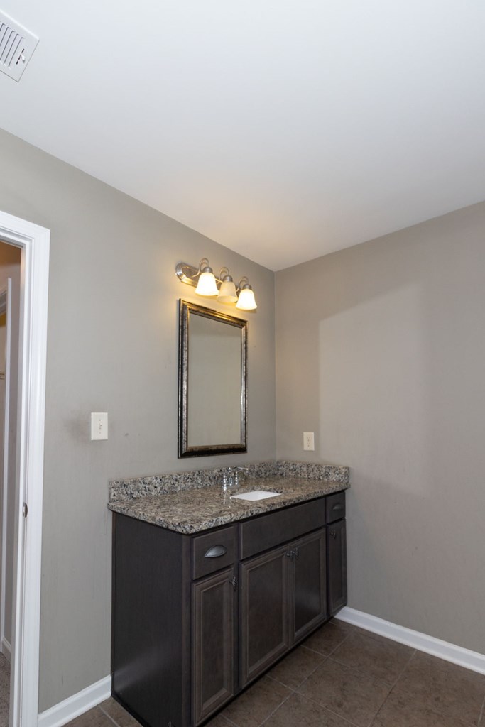 104 Pin Oak Way Hamilton, GA 31811 - Photo 25 of 41 a bathroom with a granite countertop sink and a mirror