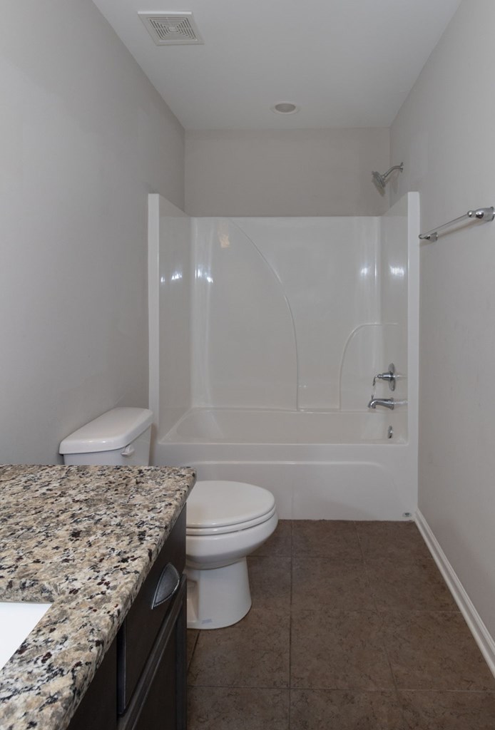 104 Pin Oak Way Hamilton, GA 31811 - Photo 30 of 41 a bathroom with a granite countertop sink a toilet and bathtub