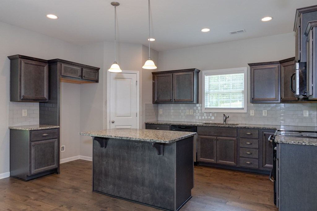 104 Pin Oak Way Hamilton, GA 31811 - Photo 6 of 41 a kitchen with stainless steel appliances granite countertop a sink a stove and a refrigerator