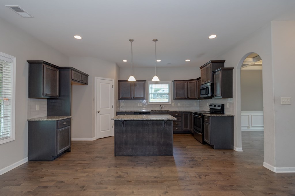104 Pin Oak Way Hamilton, GA 31811 - Photo 7 of 41 a large kitchen with a large counter top stainless steel appliances and cabinets