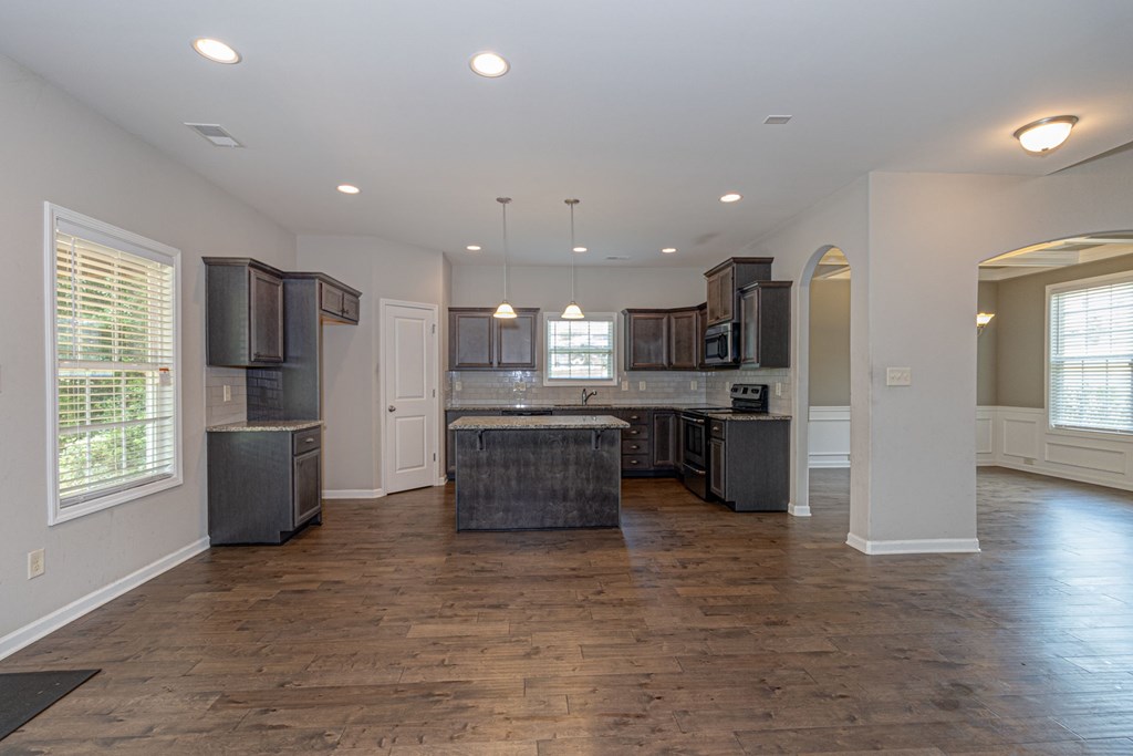 104 Pin Oak Way Hamilton, GA 31811 - Photo 8 of 41 a kitchen with stainless steel appliances kitchen island granite countertop a refrigerator and a stove top oven