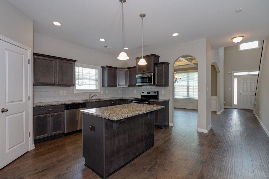 104 Pin Oak Way Hamilton, GA 31811 - Photo 9 of 41 a kitchen with stainless steel appliances granite countertop wooden cabinets a sink dishwasher a stove and a refrigerator