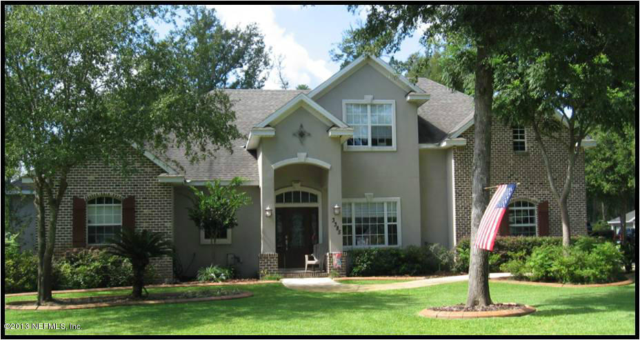3385 Kings Road South St. Augustine, FL 32086 - Photo 1 of 36 a front view of a house with a yard