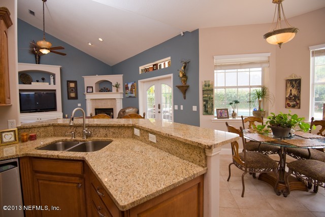 3385 Kings Road South St. Augustine, FL 32086 - Photo 13 of 36 a kitchen with a sink a counter and chairs